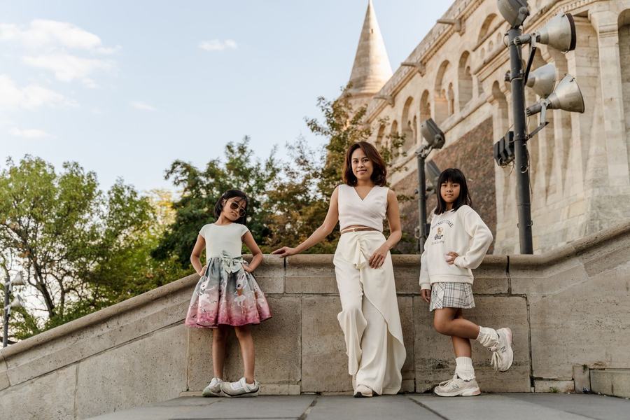 A mother and her two daughters posing on the stone stairs of Fisherman's Bastion