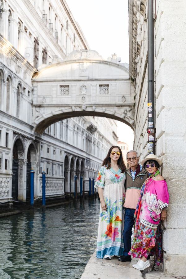 A woman and her parents standing below the Bridge of Sighs