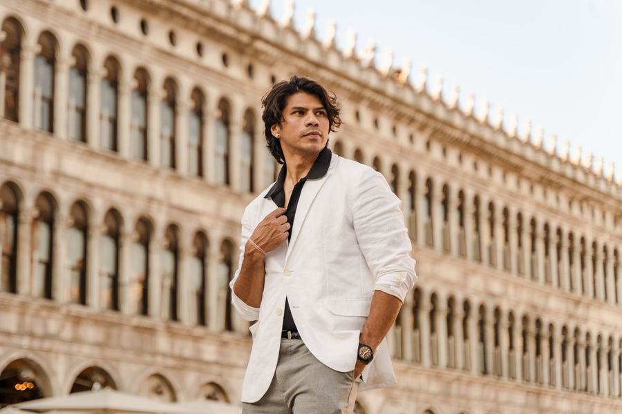 A man in a white blazer in St Mark's Square